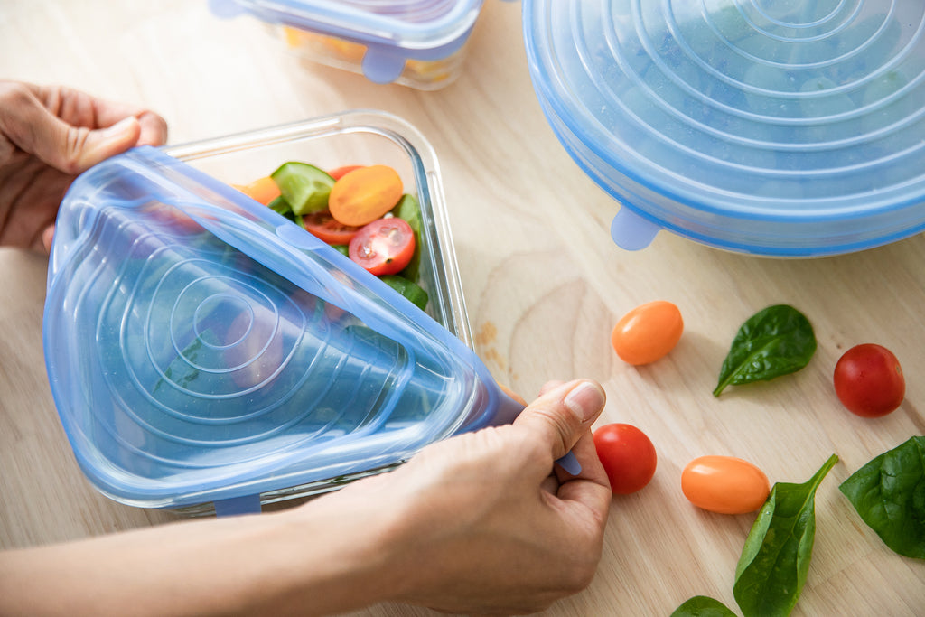 silicone stretch lid is covering salad in square container