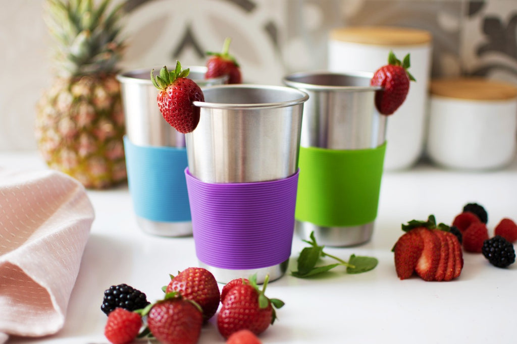 Strawberry juice in stainless steel cups with silicone sleeves