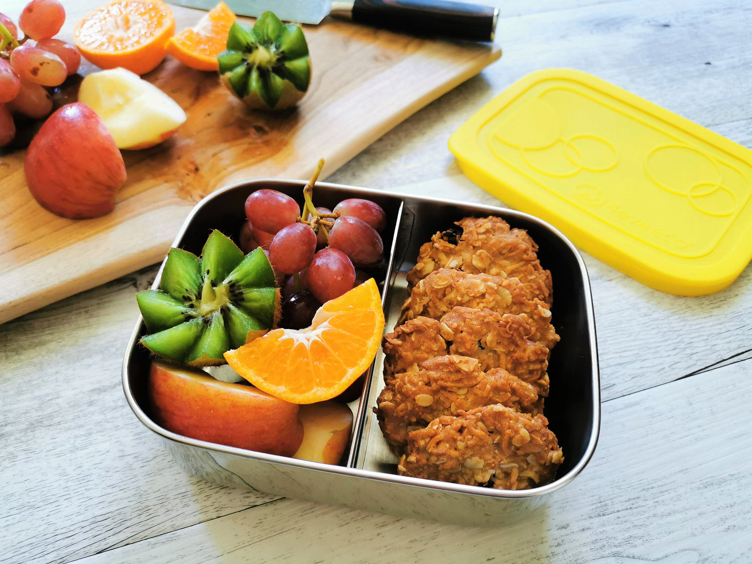 Homemade cookies and fruits in 2 section lunch box