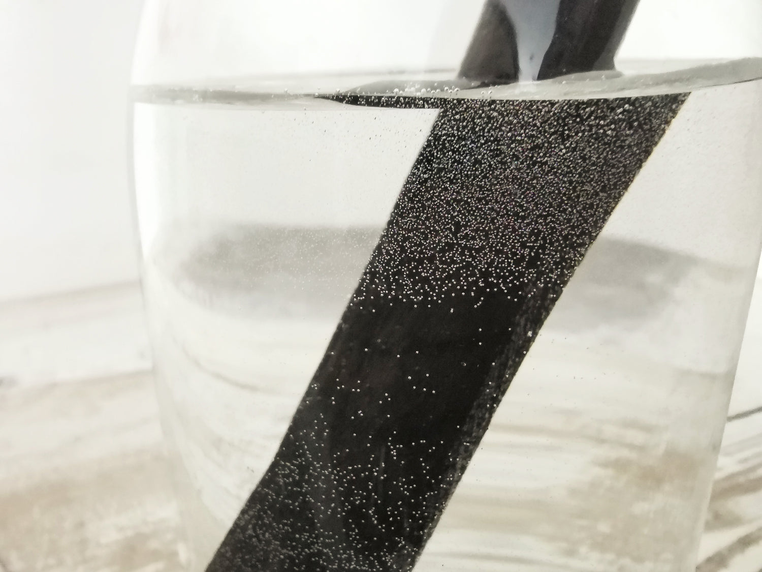 Binchotan charcoal water filter in a water jug filled with tap water