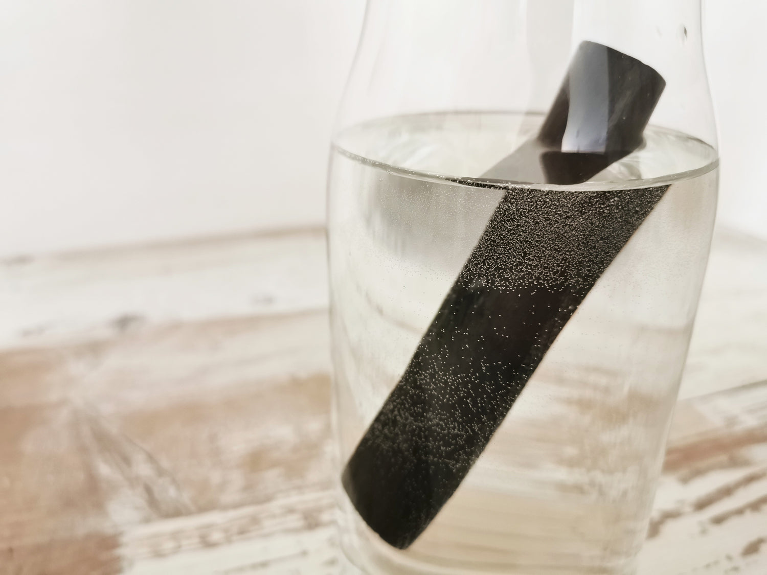 Binchotan charcoal water filter in a water jug filled with tap water