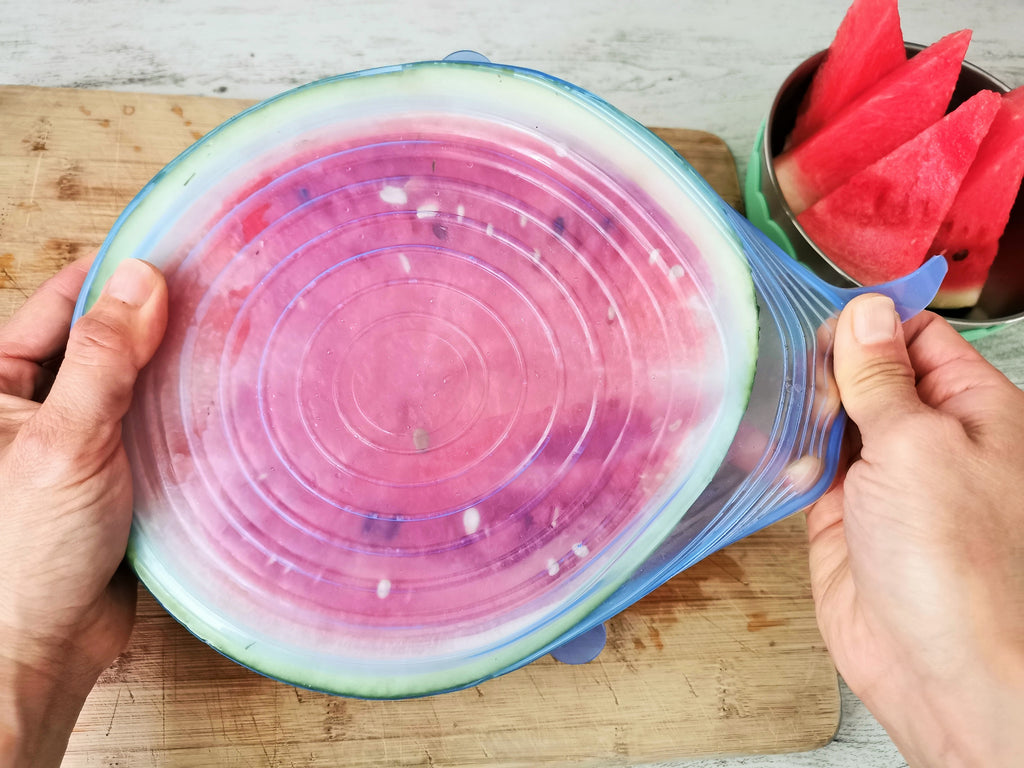 Silicone lid is covering directly on half cut watermelon
