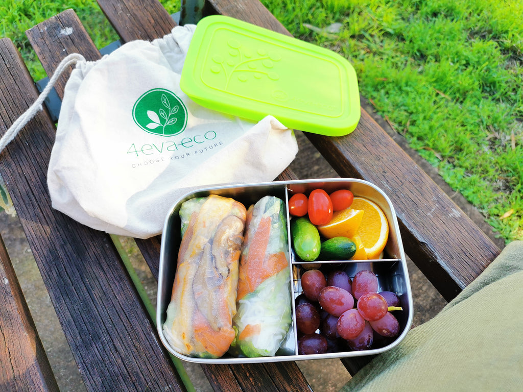 Vegan spring rolls, grapes and salad in 3 section lunch box