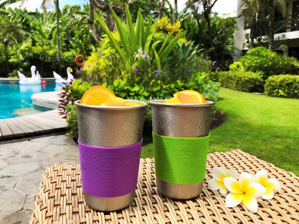Fruit juice in stainless steel cups, purple and green